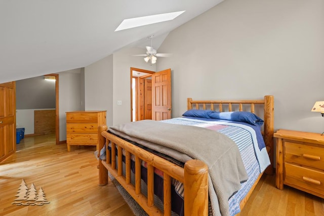 6609 Honey Ln, Johannesburg, MI 49751 - bedroom featuring lofted ceiling, a skylight, light wood-style floors, and a ceiling fan