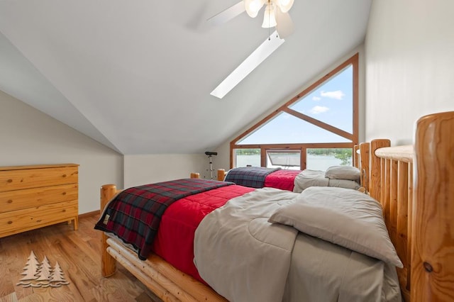 6609 Honey Ln, Johannesburg, MI 49751 - bedroom featuring lofted ceiling, a ceiling fan, and wood finished floors