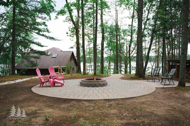 6609 Honey Ln, Johannesburg, MI 49751 - view of patio with a fire pit and an outbuilding