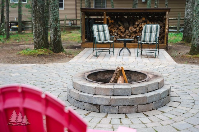 6609 Honey Ln, Johannesburg, MI 49751 - view of patio / terrace with an outdoor fire pit