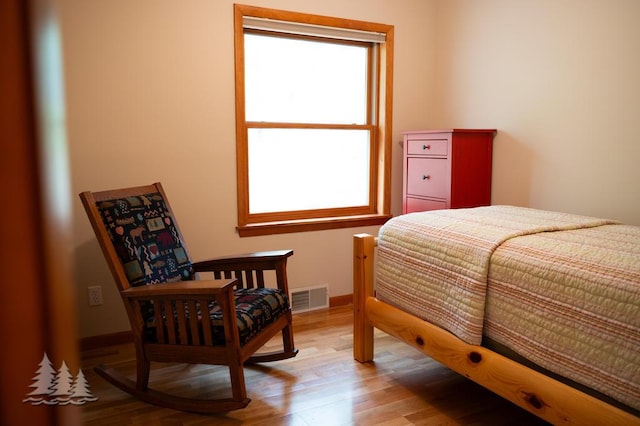 6609 Honey Ln, Johannesburg, MI 49751 - bedroom with multiple windows and light wood-style floors