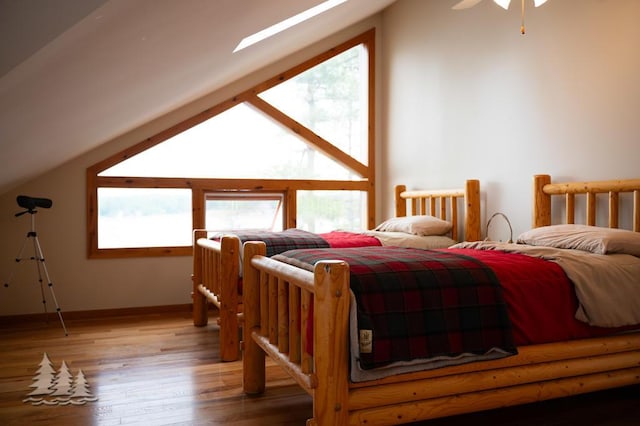 6609 Honey Ln, Johannesburg, MI 49751 - bedroom featuring wood finished floors and vaulted ceiling