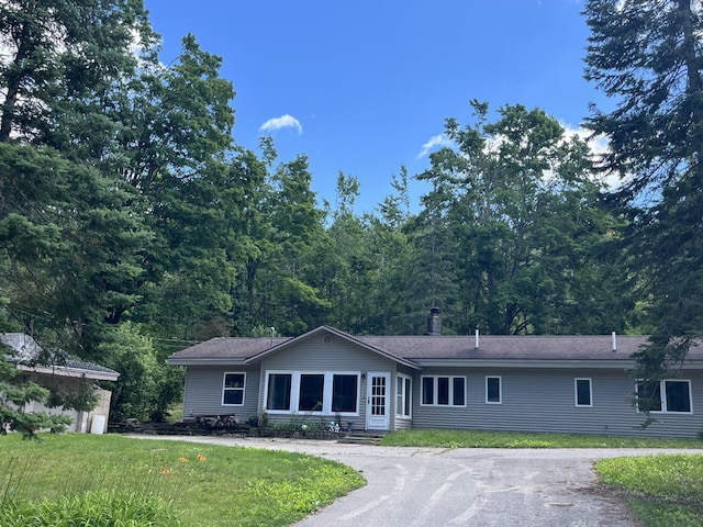 2359 Watson Hills Trl, Vanderbilt, MI 49795 - ranch-style house featuring asphalt driveway and a front lawn