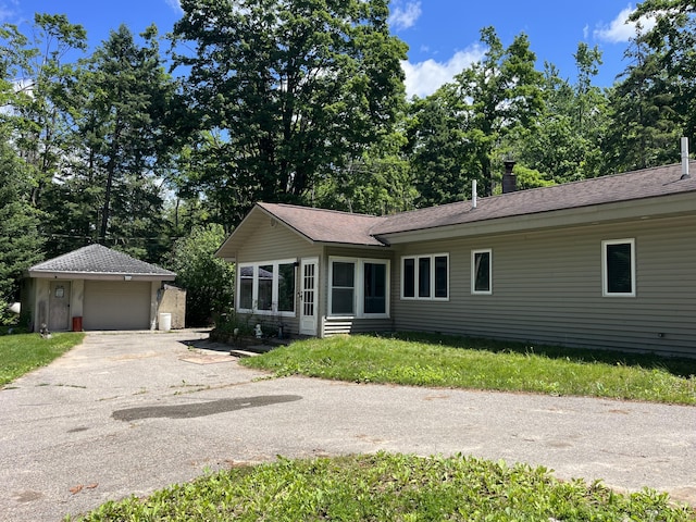 2359 Watson Hills Trl, Vanderbilt, MI 49795 - ranch-style house featuring an outdoor structure, asphalt driveway, view of scattered trees, and a garage