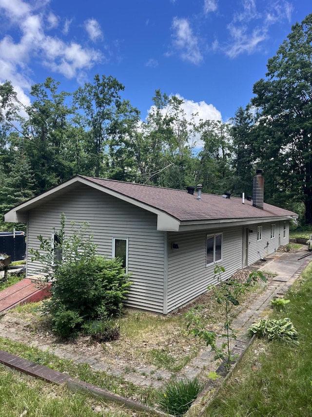 2359 Watson Hills Trl, Vanderbilt, MI 49795 - view of property exterior with a chimney and roof with shingles