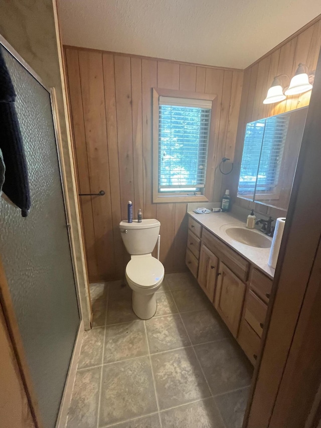 2359 Watson Hills Trl, Vanderbilt, MI 49795 - bathroom featuring vanity, a stall shower, wooden walls, and tile patterned flooring