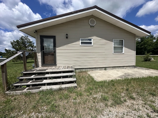 4974 Meridian Line Rd, Johannesburg, MI 49751 - back of property with a patio and a yard