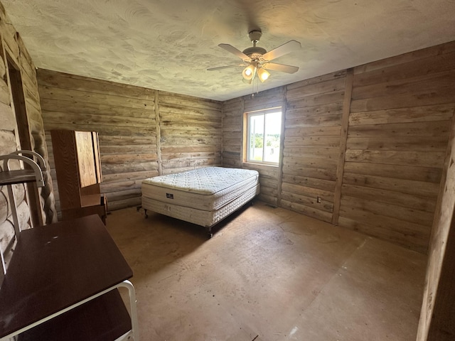 4974 Meridian Line Rd, Johannesburg, MI 49751 - bedroom featuring concrete flooring, a textured ceiling, and ceiling fan