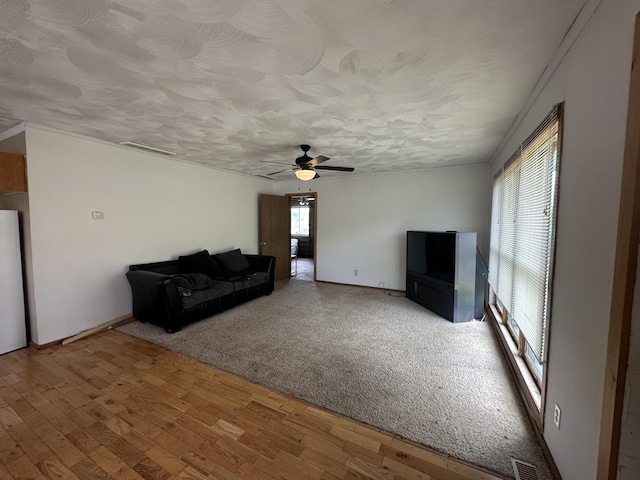 4974 Meridian Line Rd, Johannesburg, MI 49751 - unfurnished living room with wood finished floors, a ceiling fan, and a textured ceiling