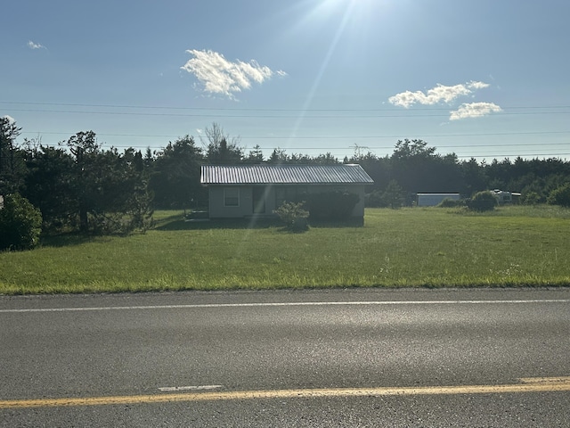 4974 Meridian Line Rd, Johannesburg, MI 49751 - view of front of home featuring a metal roof and a front yard
