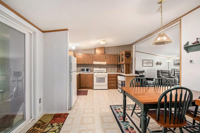 6691 Boone Ln, Vanderbilt, MI 49795 - kitchen featuring white appliances, light countertops, brown cabinets, light floors, and under cabinet range hood