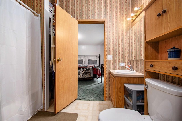 6691 Boone Ln, Vanderbilt, MI 49795 - ensuite bathroom featuring wallpapered walls, vanity, tile patterned floors, and a shower with shower curtain