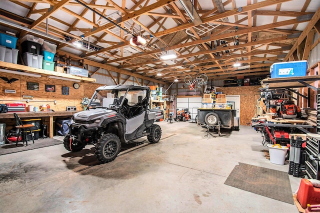 6691 Boone Ln, Vanderbilt, MI 49795 - garage featuring a workshop area