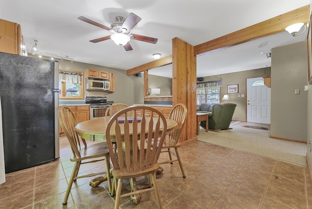 120 Clyde St, Roscommon, MI 48653 - dining room featuring a ceiling fan, beamed ceiling, track lighting, light tile patterned floors, and light colored carpet