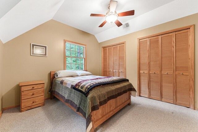 120 Clyde St, Roscommon, MI 48653 - bedroom with light colored carpet, multiple closets, vaulted ceiling, and ceiling fan