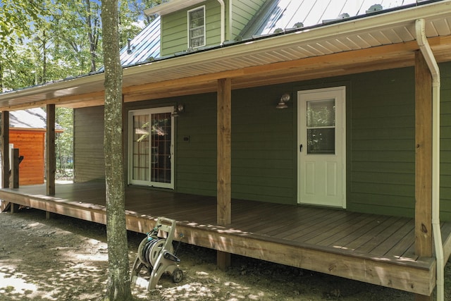 120 Clyde St, Roscommon, MI 48653 - entrance to property with a wooden deck, a metal roof, and a standing seam roof
