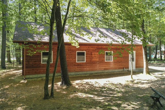 120 Clyde St, Roscommon, MI 48653 - view of side of home featuring roof with shingles