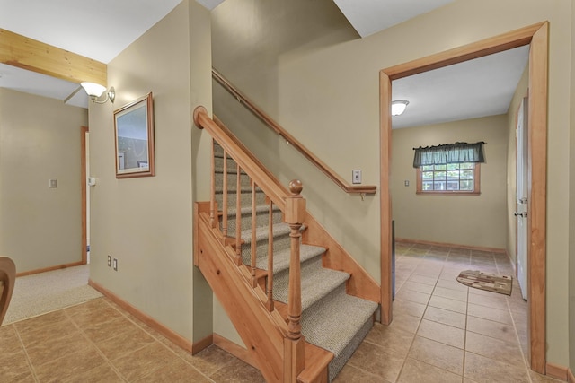 120 Clyde St, Roscommon, MI 48653 - stairway with baseboards and tile patterned flooring