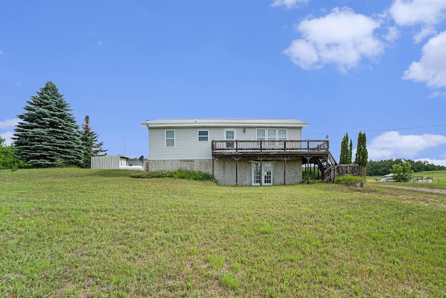 1680 W Huffman Lake Rd, Vanderbilt, MI 49795 - rear view of property featuring a deck, a yard, and stairs