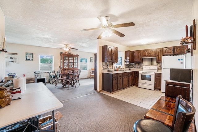 1680 W Huffman Lake Rd, Vanderbilt, MI 49795 - kitchen featuring white appliances, ceiling fan, light countertops, a textured ceiling, and dark brown cabinetry