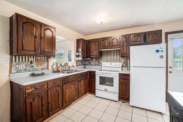1680 W Huffman Lake Rd, Vanderbilt, MI 49795 - kitchen featuring white appliances, light countertops, dark brown cabinets, a textured ceiling, and light tile patterned floors