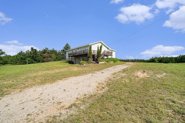 1680 W Huffman Lake Rd, Vanderbilt, MI 49795 - view of front facade featuring dirt driveway, a wooden deck, and a front yard