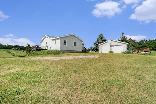 1680 W Huffman Lake Rd, Vanderbilt, MI 49795 - view of green lawn featuring a garage, an outdoor structure, and a wooden deck