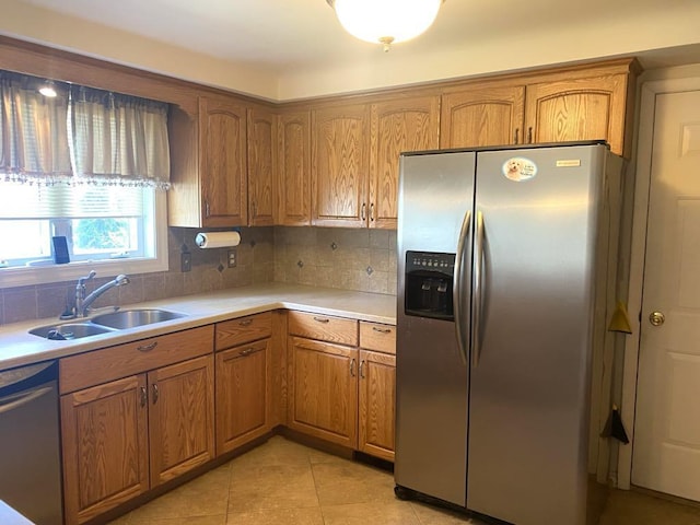140 Oriole Dr, Alpena, MI 49707 - kitchen with appliances with stainless steel finishes, brown cabinets, light countertops, and tasteful backsplash
