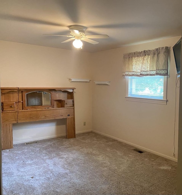 140 Oriole Dr, Alpena, MI 49707 - unfurnished bedroom featuring carpet floors and ceiling fan