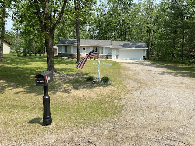 3350 Woodcrest Dr, Lewiston, MI 49756 - ranch-style house with a garage, dirt driveway, and a front lawn