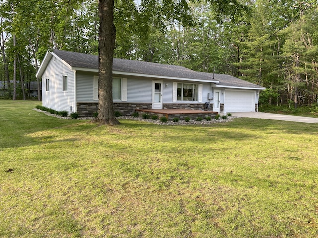 3350 Woodcrest Dr, Lewiston, MI 49756 - ranch-style home with an attached garage, driveway, a front lawn, stone siding, and view of wooded area