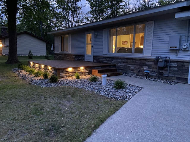 3350 Woodcrest Dr, Lewiston, MI 49756 - view of front of house with stone siding and a front yard