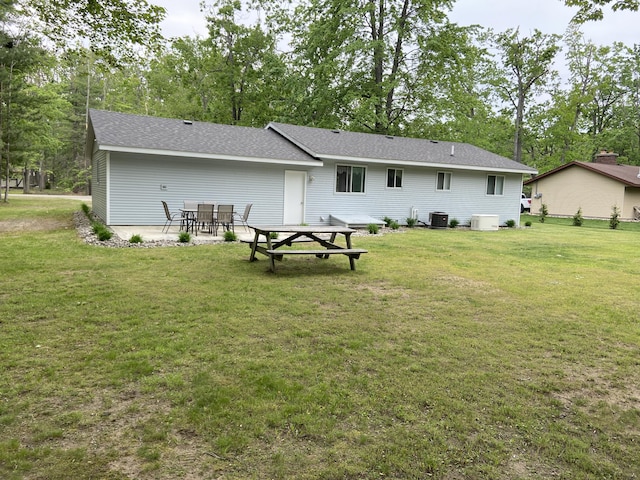 3350 Woodcrest Dr, Lewiston, MI 49756 - rear view of property featuring a yard