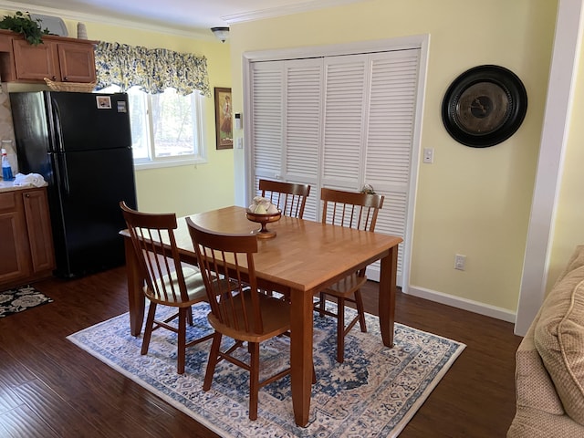 3350 Woodcrest Dr, Lewiston, MI 49756 - dining area featuring crown molding and dark wood finished floors