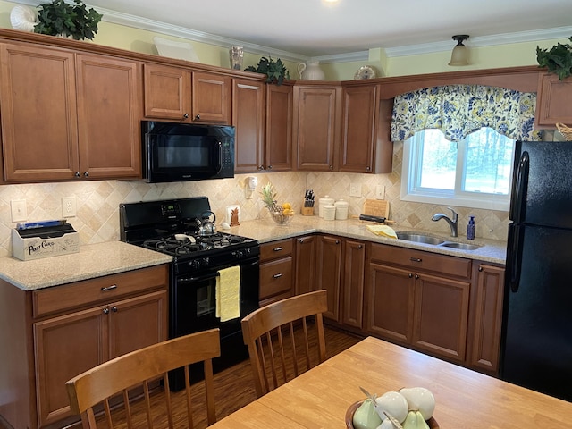3350 Woodcrest Dr, Lewiston, MI 49756 - kitchen featuring black appliances, decorative backsplash, crown molding, light stone countertops, and brown cabinetry