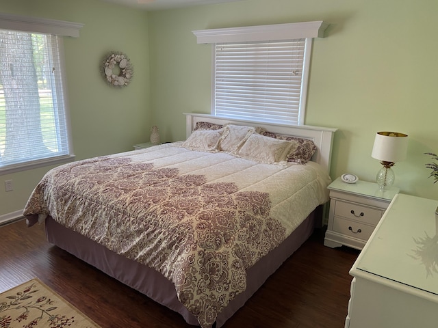 3350 Woodcrest Dr, Lewiston, MI 49756 - bedroom with dark wood finished floors and baseboards