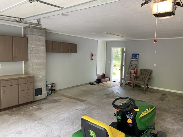 3350 Woodcrest Dr, Lewiston, MI 49756 - garage featuring a garage door opener and baseboards