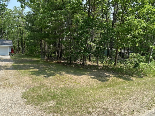 3350 Woodcrest Dr, Lewiston, MI 49756 - view of grassy yard with a garage