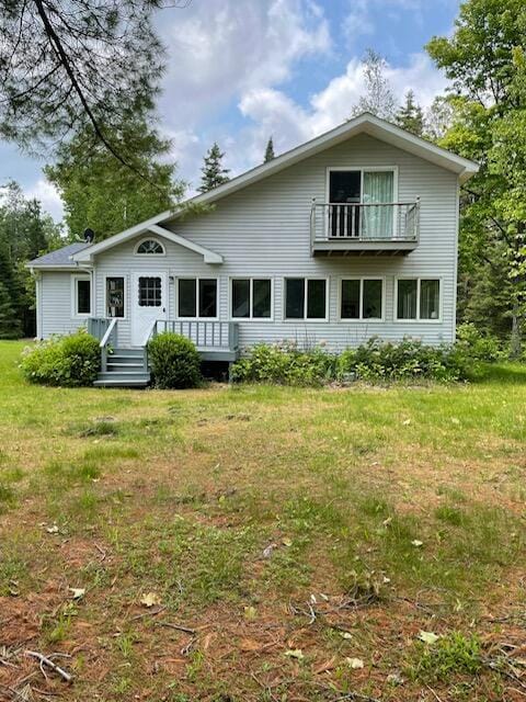 22551 Theiner Trl, Hillman, MI 49746 - back of property with a balcony and a lawn