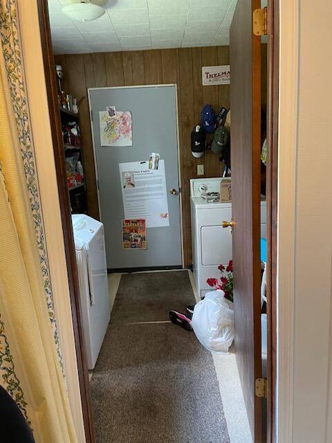 22551 Theiner Trl, Hillman, MI 49746 - laundry room featuring separate washer and dryer, wood walls, and carpet