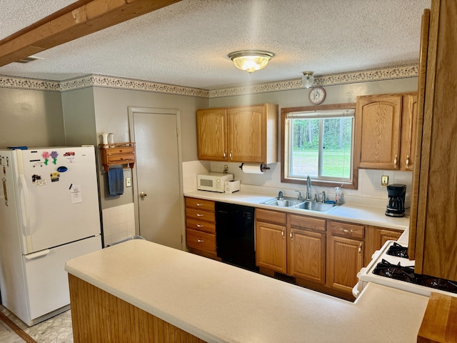 36 S Mcmasters Bridge Rd, Grayling, MI 49738 - kitchen with white appliances, a textured ceiling, light countertops, and a peninsula