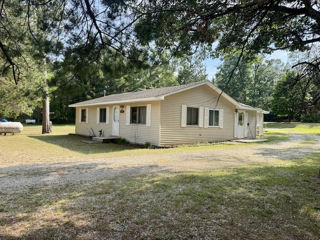 36 S Mcmasters Bridge Rd, Grayling, MI 49738 - view of front of house featuring a front lawn and view of wooded area