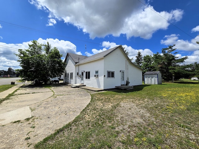 7931 Mill St, Vanderbilt, MI 49795 - view of property exterior featuring a storage shed and a lawn