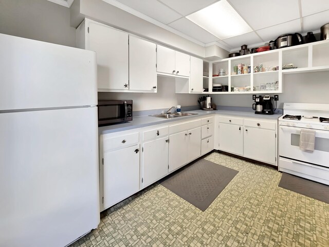 7931 Mill St, Vanderbilt, MI 49795 - kitchen with white appliances, open shelves, white cabinetry, light countertops, and light floors