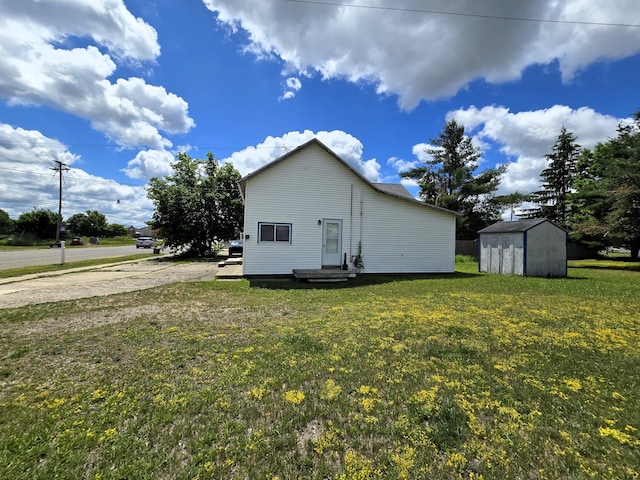 7931 Mill St, Vanderbilt, MI 49795 - view of home's exterior with a storage unit and a yard