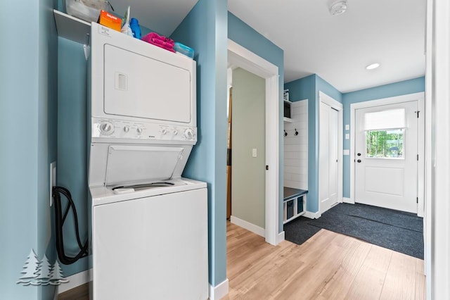 4620 Pinewood Dr, Lewiston, MI 49756 - washroom with stacked washer and clothes dryer and wood finished floors