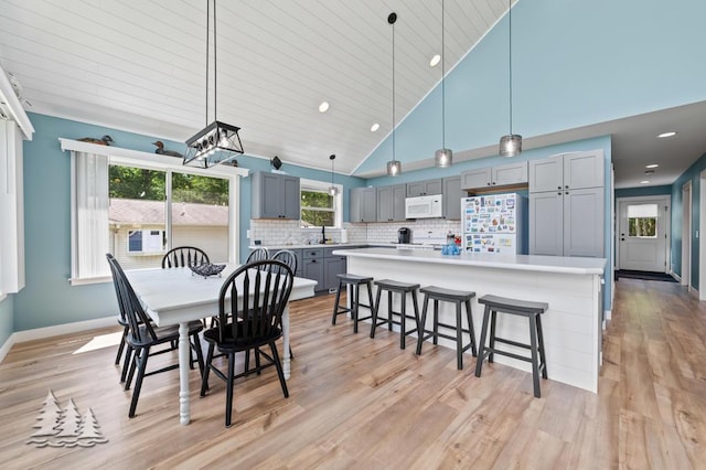 4620 Pinewood Dr, Lewiston, MI 49756 - dining area with light wood-style flooring, recessed lighting, and high vaulted ceiling