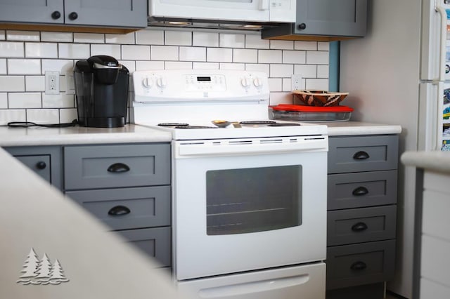 4620 Pinewood Dr, Lewiston, MI 49756 - kitchen featuring white appliances, gray cabinetry, light countertops, and backsplash