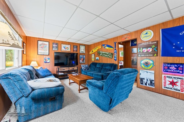 2911 Birch St, Lewiston, MI 49756 - living area with wooden walls, carpet flooring, and a paneled ceiling