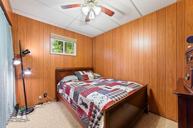 2911 Birch St, Lewiston, MI 49756 - carpeted bedroom featuring wooden walls and ceiling fan